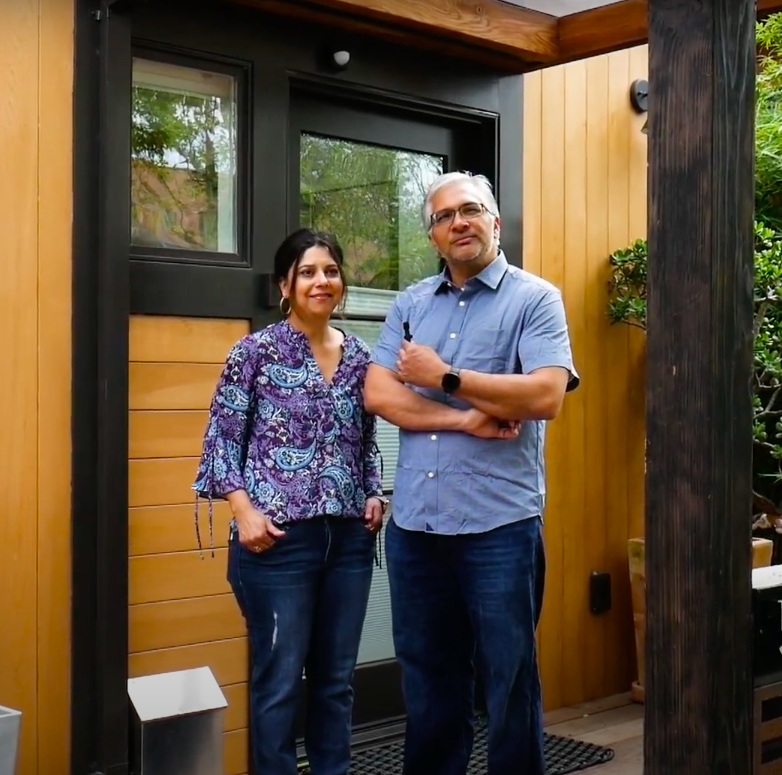 Danan and Manisha in front of house