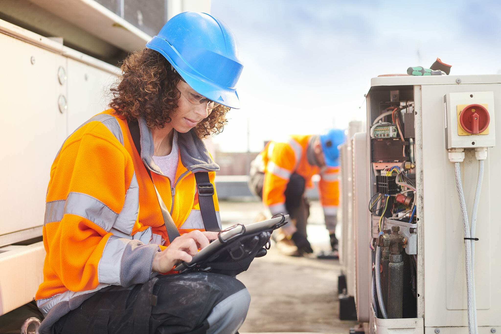 Electrician in the field working on HVAC system