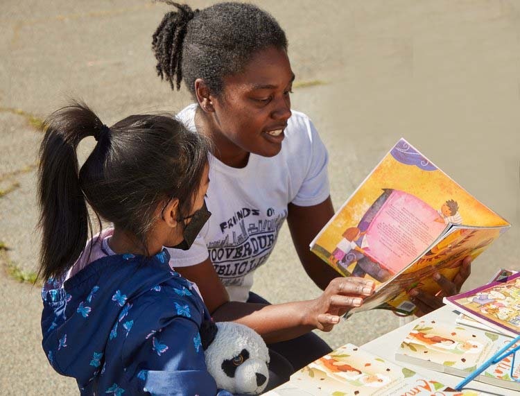 Girl with toddler reading