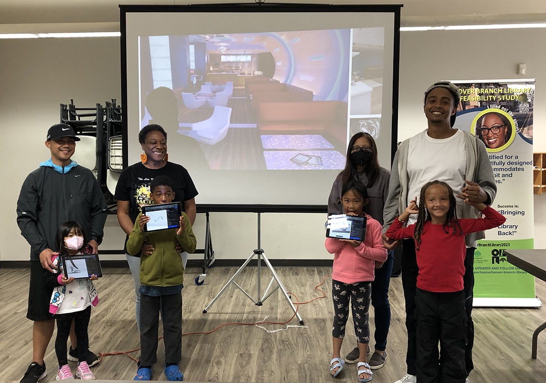 participants stand in front of a projector screen