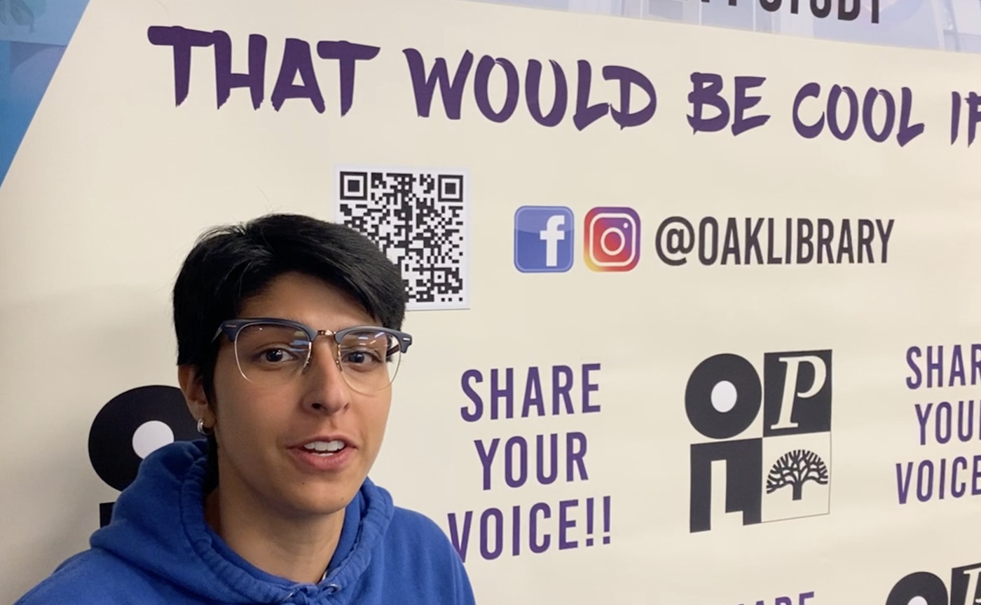Person poses in front of the 'that would be cool if...' banner