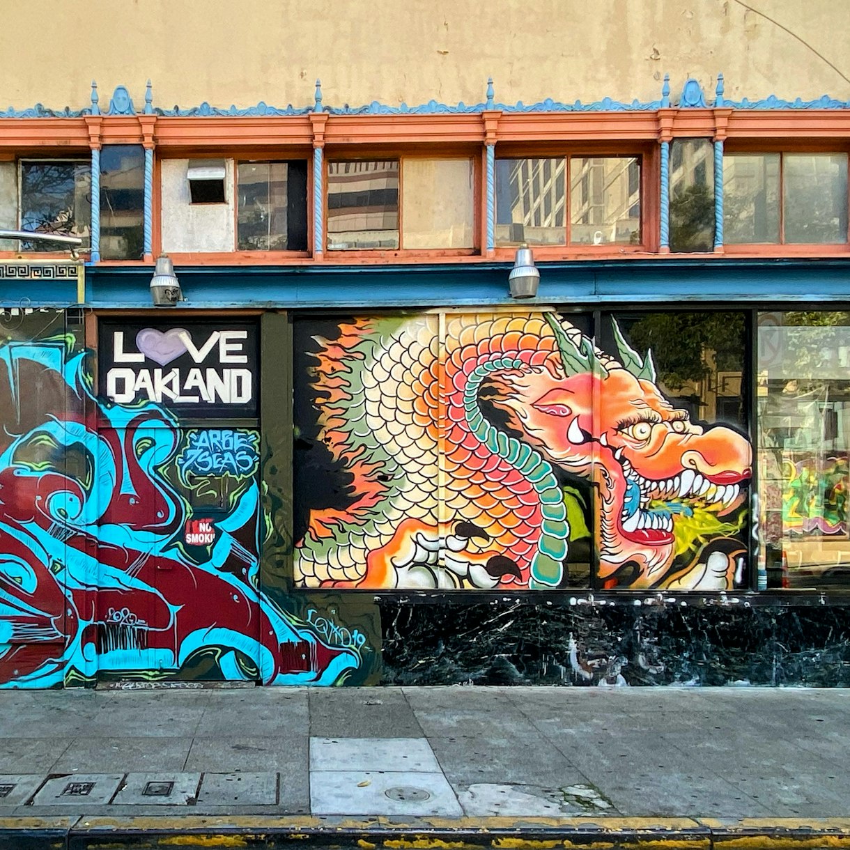 Mural of dragon, with text 'love oakland'