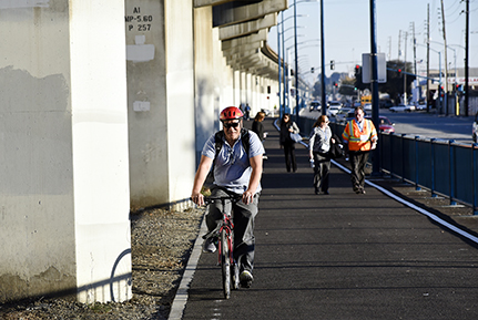 People biking and walking on East Bay Greenway