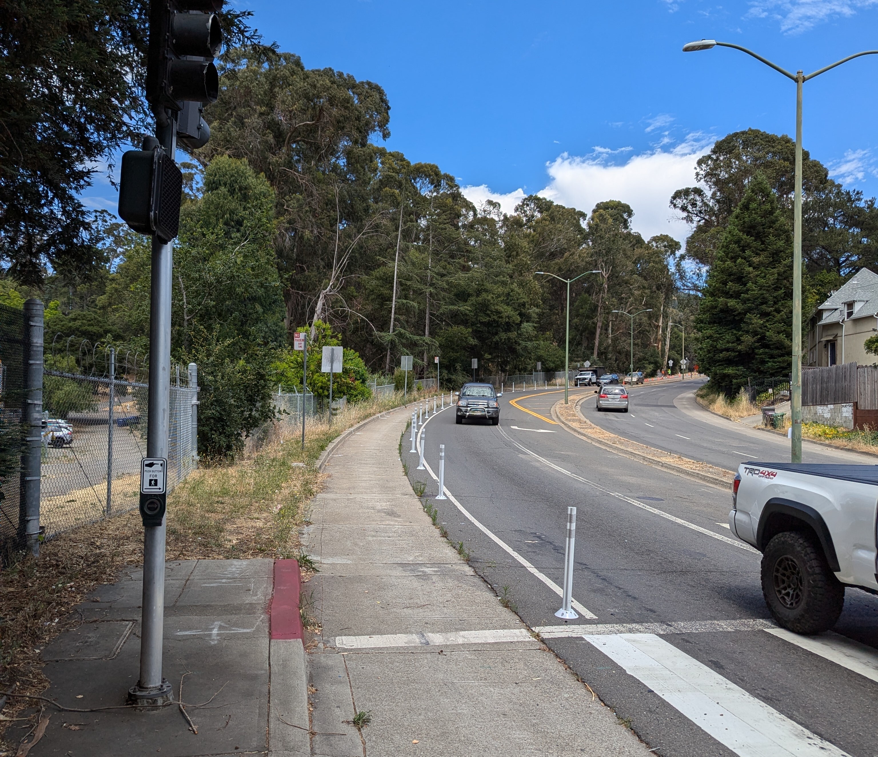 Plastic posts line the shoulder of Seminary Avenue in the downhill lane just before Outlook Avenue,, installed as part of the Rapid Response Program